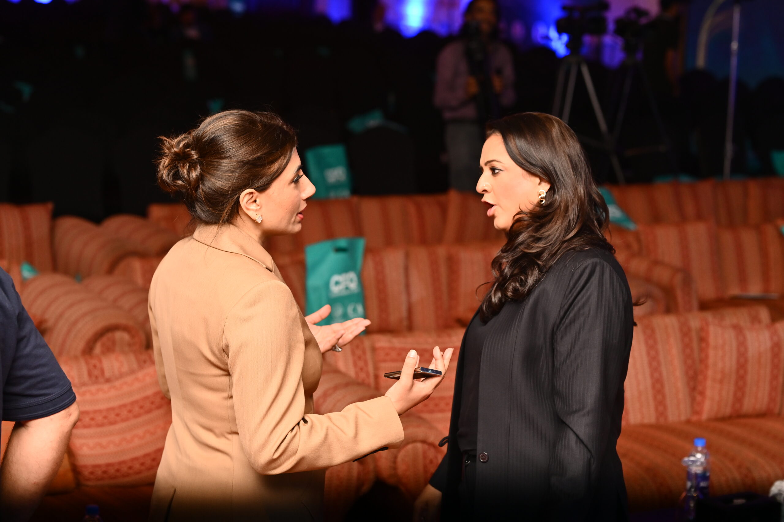 Two professionals engaged in a meaningful conversation during an event.